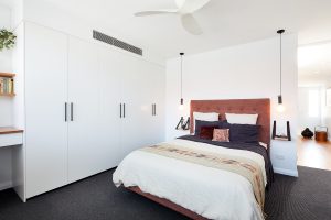 Master bedroom with custom designed wardrobe and bedhead